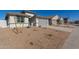 Modern, single-story home with gray garage door and gravel landscaping at 7400 E White Tail Rd, San Tan Valley, AZ 85143