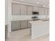 Modern kitchen with gray cabinets, quartz countertops and island at 7400 E White Tail Rd, San Tan Valley, AZ 85143