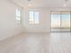 Spacious living area featuring wood-look tile flooring and sliding glass doors to patio at 7400 E White Tail Rd, San Tan Valley, AZ 85143