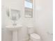 Clean powder room with pedestal sink, toilet, and oval mirror at 7400 E White Tail Rd, San Tan Valley, AZ 85143