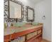 Bathroom with double sinks, a wood vanity, and green glass bowls at 2451 E Glencove St, Mesa, AZ 85213