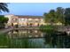 Community pond with a wooden footbridge and scenic reflections at 2660 S Equestrian Dr # 107, Gilbert, AZ 85295