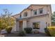 Two-story house with a tan facade, two-car garage, and landscaping at 665 W Gabrilla Ct, Casa Grande, AZ 85122