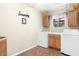 Bright laundry room with washer, dryer, cabinets, and a window at 10820 N Balboa Dr, Sun City, AZ 85351