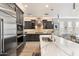 Modern kitchen with marble countertops and stainless steel appliances at 17543 E Silver Sage Ln, Rio Verde, AZ 85263