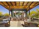 Outdoor bar and lounge area with seating, a TV, and a pergola at 17543 E Silver Sage Ln, Rio Verde, AZ 85263