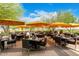 Outdoor patio area with multiple tables and umbrellas at 17543 E Silver Sage Ln, Rio Verde, AZ 85263