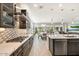 Open concept kitchen with stainless steel appliances and marble countertops at 17543 E Silver Sage Ln, Rio Verde, AZ 85263