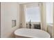 Stunning bathroom featuring a deep soaking tub and a window at 17743 W Evans Dr, Surprise, AZ 85388