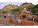 Outdoor patio with stone fireplace and seating area at 5123 E Mcdonald Dr, Paradise Valley, AZ 85253