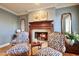 Sitting area with fireplace and two ornate armchairs at 5123 E Mcdonald Dr, Paradise Valley, AZ 85253