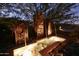 Serene water feature with illuminated rock wall accents at 5123 E Mcdonald Dr, Paradise Valley, AZ 85253