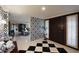 Elegant entryway with checkerboard floor, patterned wallpaper, and view to living room at 5123 E Mcdonald Dr, Paradise Valley, AZ 85253
