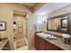 Bright bathroom with granite countertops, a walk-in shower, and large mirror at 5123 E Mcdonald Dr, Paradise Valley, AZ 85253