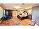 Bedroom with hardwood floors, a large dresser, and a sitting chair at 5123 E Mcdonald Dr, Paradise Valley, AZ 85253
