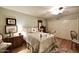 Charming bedroom with antique brass bed, hardwood floors, and built-in closet at 5123 E Mcdonald Dr, Paradise Valley, AZ 85253