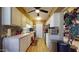White kitchen with tile floor and stainless steel appliances at 17447 N 99Th Dr, Sun City, AZ 85373