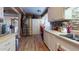 White kitchen with stainless steel appliances and tile backsplash at 17447 N 99Th Dr, Sun City, AZ 85373