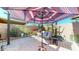 Relaxing patio with umbrella, seating, and lush landscaping at 17447 N 99Th Dr, Sun City, AZ 85373