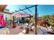 Relaxing patio area with pergola, seating, and colorful plants at 17447 N 99Th Dr, Sun City, AZ 85373