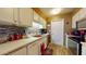 Clean kitchen, white cabinets, tile backsplash, and modern appliances at 17447 N 99Th Dr, Sun City, AZ 85373
