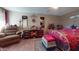 Main bedroom with a comfortable sitting area and large bed at 17447 N 99Th Dr, Sun City, AZ 85373