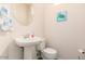 Clean bathroom with pedestal sink, toilet and a decorative turtle painting at 7959 W Waltann Ln, Peoria, AZ 85382