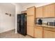 Kitchen with wood cabinets, granite countertops and black appliances at 7959 W Waltann Ln, Peoria, AZ 85382