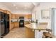 Kitchen with wood cabinets, granite counters, and black appliances at 7959 W Waltann Ln, Peoria, AZ 85382