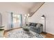 Cozy living room featuring a gray couch and glass coffee table at 7959 W Waltann Ln, Peoria, AZ 85382
