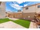 Landscaped backyard with artificial turf and planter boxes at 7959 W Waltann Ln, Peoria, AZ 85382