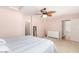 Bright bedroom with ceiling fan, dresser, and access to bathroom at 7959 W Waltann Ln, Peoria, AZ 85382