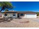 Single-story home with a white exterior and a gravel yard at 15840 N 22Nd St, Phoenix, AZ 85022