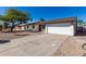 Newly renovated home with a white exterior, attached garage, and gravel landscaping at 15840 N 22Nd St, Phoenix, AZ 85022