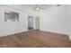 Spacious bedroom with wood-look flooring and a view into another room at 15840 N 22Nd St, Phoenix, AZ 85022