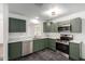Renovated kitchen featuring stylish green cabinets and quartz countertops at 15840 N 22Nd St, Phoenix, AZ 85022