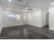 Bright living room with dark gray tile floors and a ceiling fan at 15840 N 22Nd St, Phoenix, AZ 85022