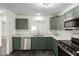 Updated kitchen with green cabinets, stainless steel appliances and quartz countertops at 15840 N 22Nd St, Phoenix, AZ 85022