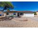 Single-story home with a white exterior and a gravel yard at 15840 N 22Nd St, Phoenix, AZ 85022