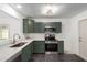 Modern kitchen with stainless steel appliances and green cabinets at 15840 N 22Nd St, Phoenix, AZ 85022