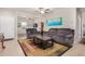 Bright living room featuring comfortable seating and a large flat-screen TV at 22608 W Gardenia Dr, Buckeye, AZ 85326