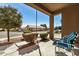 Covered porch with view of neighborhood and blue striped chairs at 22608 W Gardenia Dr, Buckeye, AZ 85326