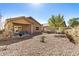 Spacious backyard with gravel landscaping and a covered patio at 22608 W Gardenia Dr, Buckeye, AZ 85326