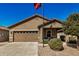 Tan house with two-car garage and landscaped yard at 22608 W Gardenia Dr, Buckeye, AZ 85326