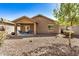 House exterior and backyard with covered patio and gravel at 22608 W Gardenia Dr, Buckeye, AZ 85326