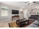 Spacious living room with a large TV and comfy seating area at 22608 W Gardenia Dr, Buckeye, AZ 85326