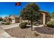 Tan houses with two-car garages and landscaped yards at 22608 W Gardenia Dr, Buckeye, AZ 85326