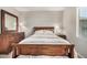 Bright bedroom with wood furniture and large window at 22608 W Gardenia Dr, Buckeye, AZ 85326