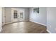 Bright bedroom with wood-look tile flooring and French doors at 13220 W Hyacinth Dr, Sun City West, AZ 85375