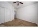 Spacious bedroom with double-door closet and ceiling fan at 17365 N Cave Creek Rd # 246, Phoenix, AZ 85032